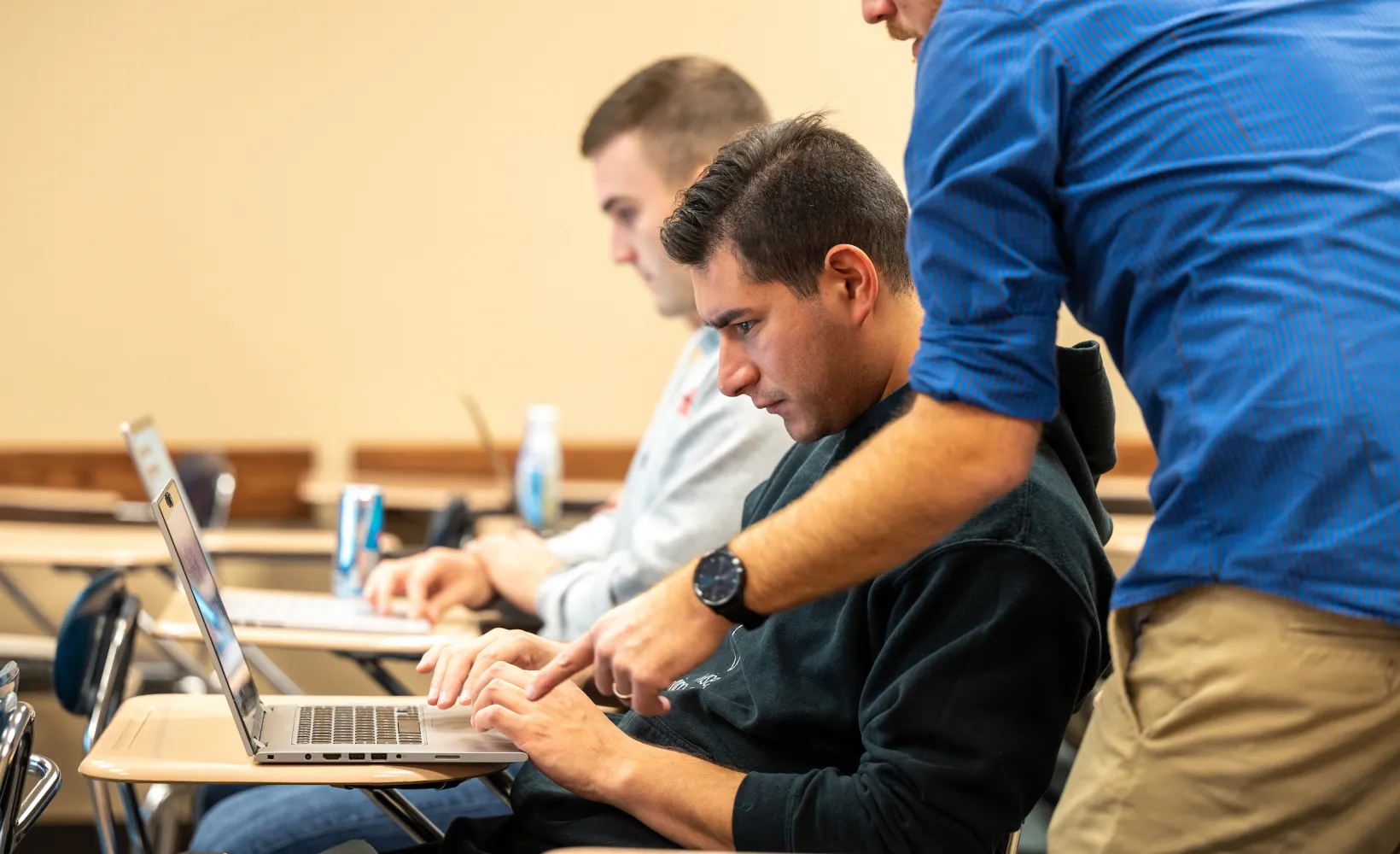Sociology faculty helping a student during class