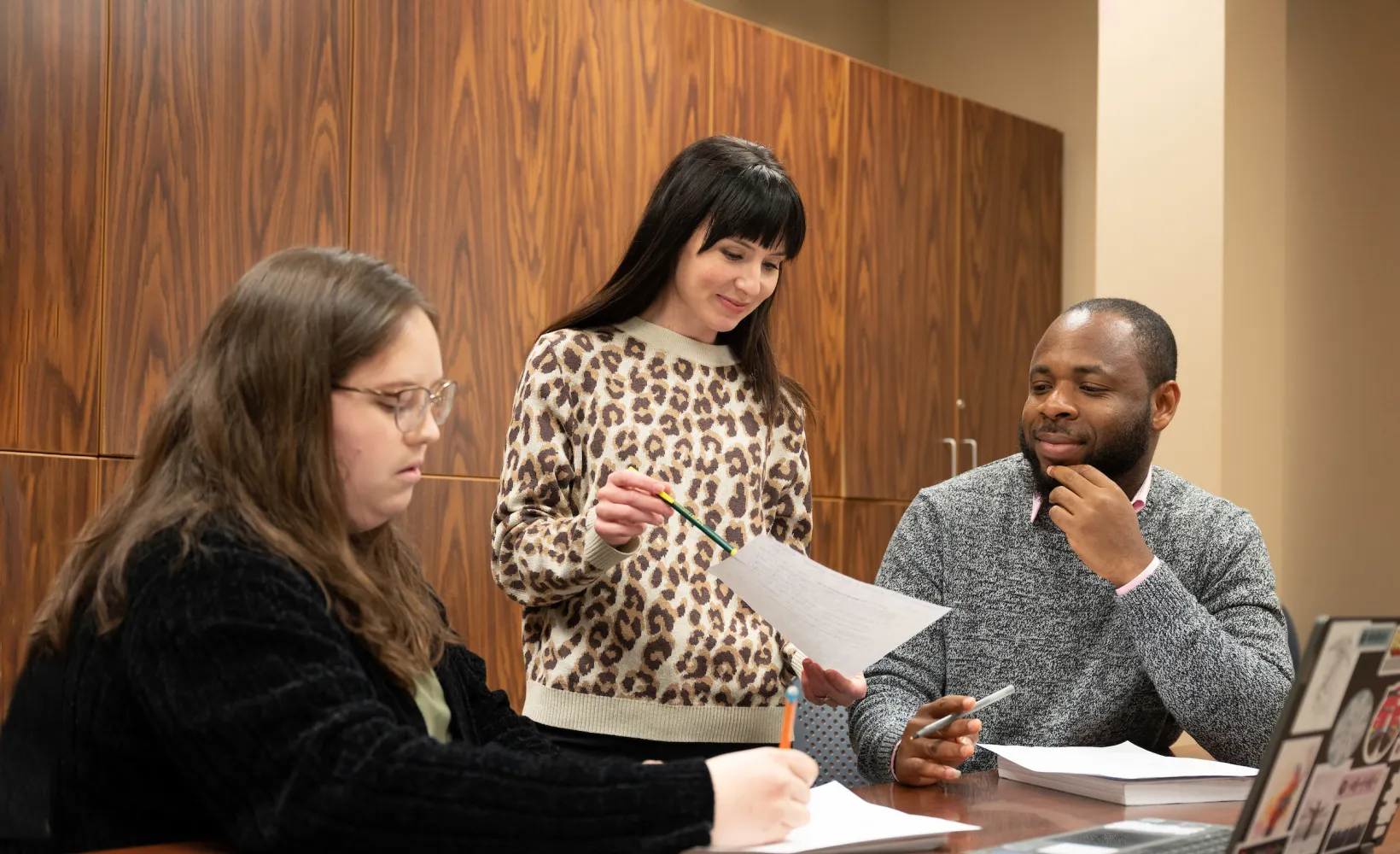 graduate students working on a project in a classroom