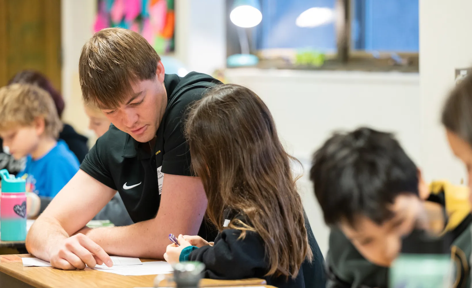 NDSU Education student helping children in the classroom