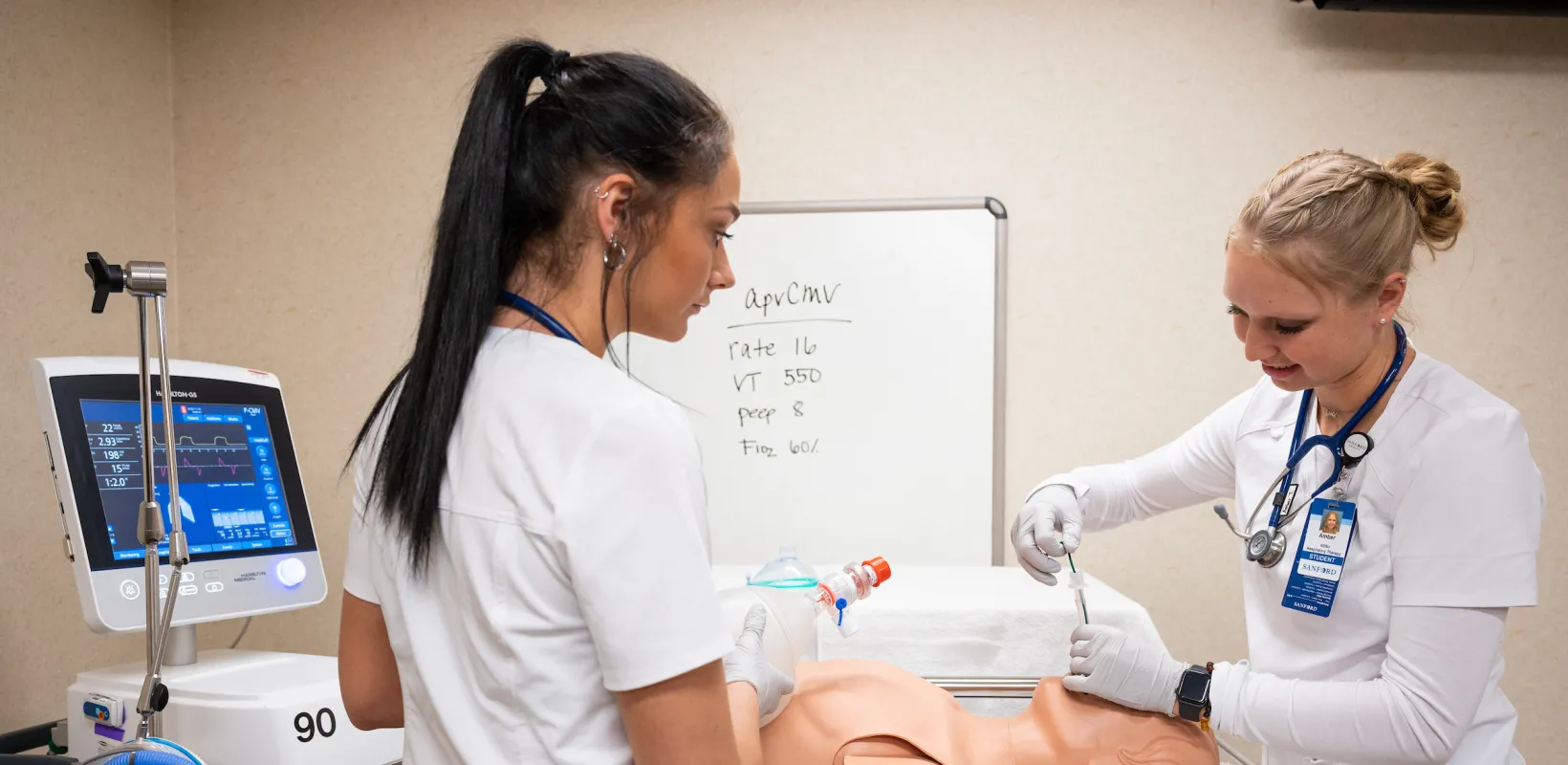 students practicing procedures with a dummy