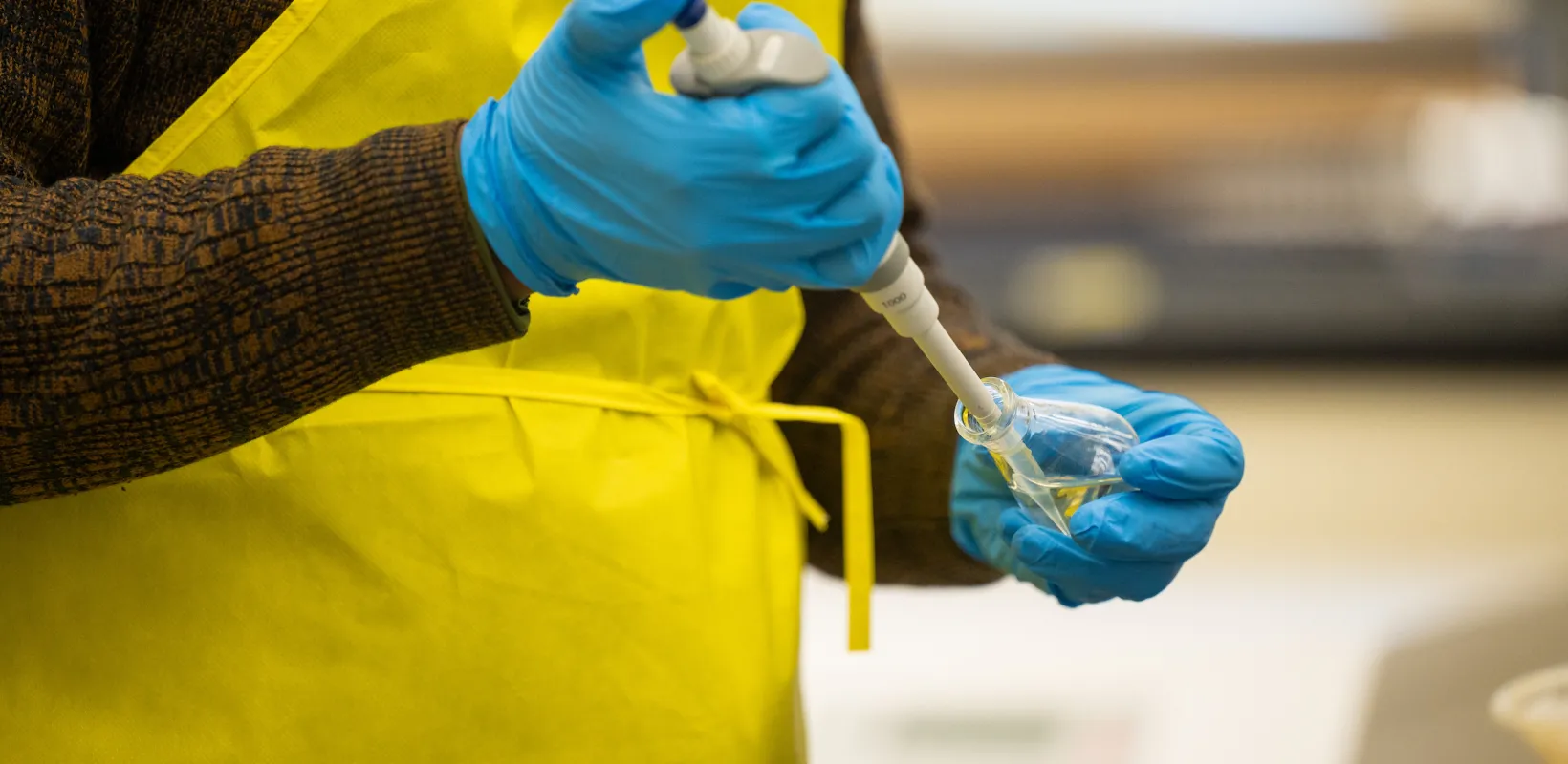 student working with a sample in a syringe