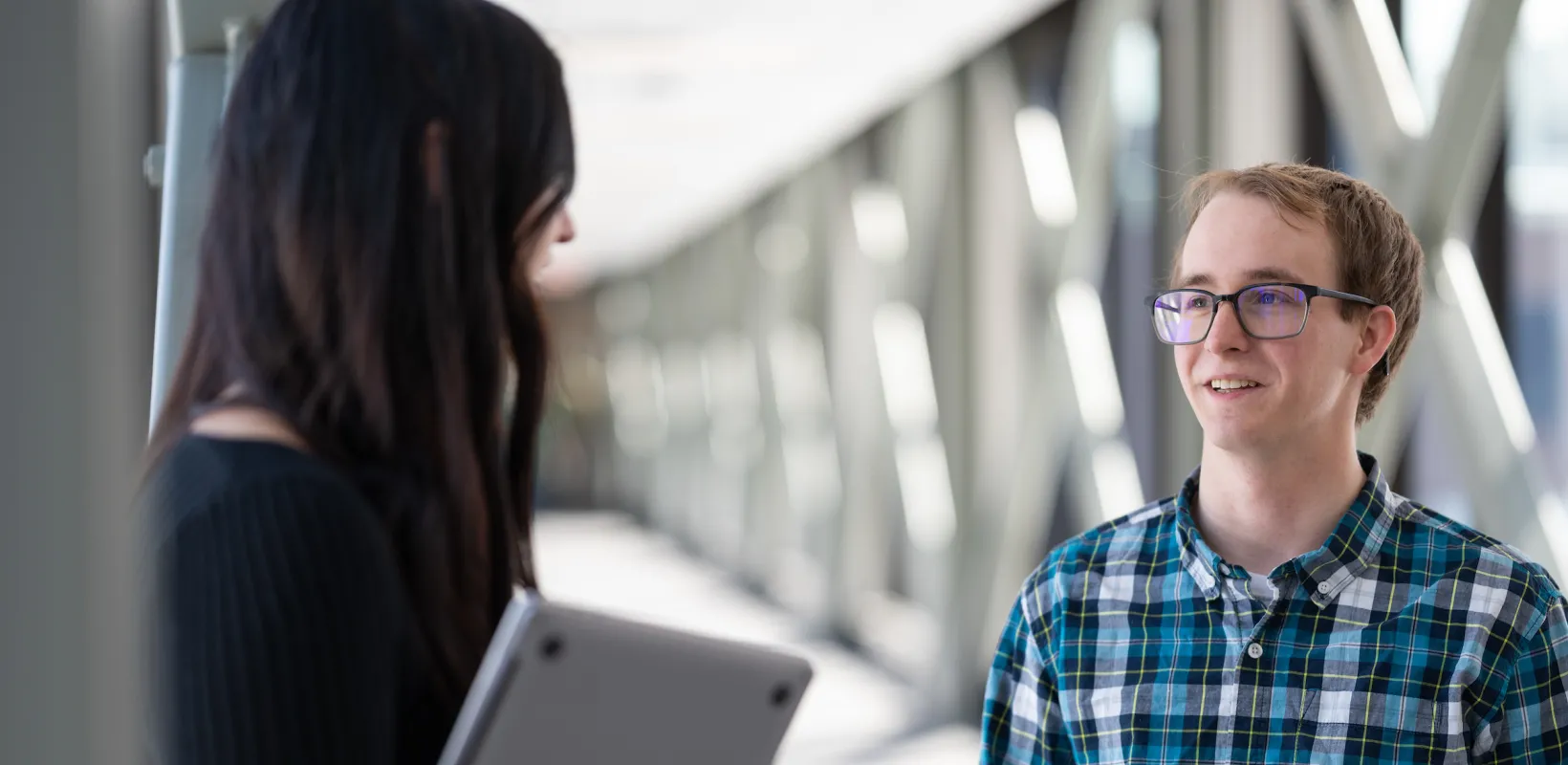 students speaking in a hallway