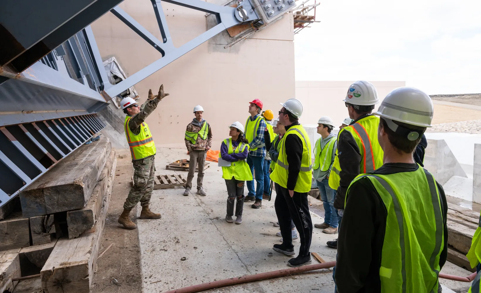 civil engineering students touring a construction site and listening to the foreman