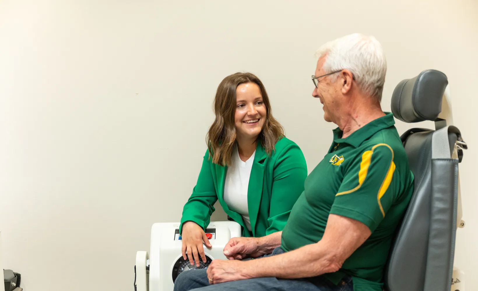 student talking to a patient in a lab