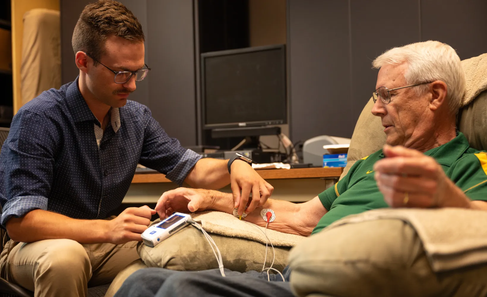 student conducting research on a participant in the Healthy Aging Lab