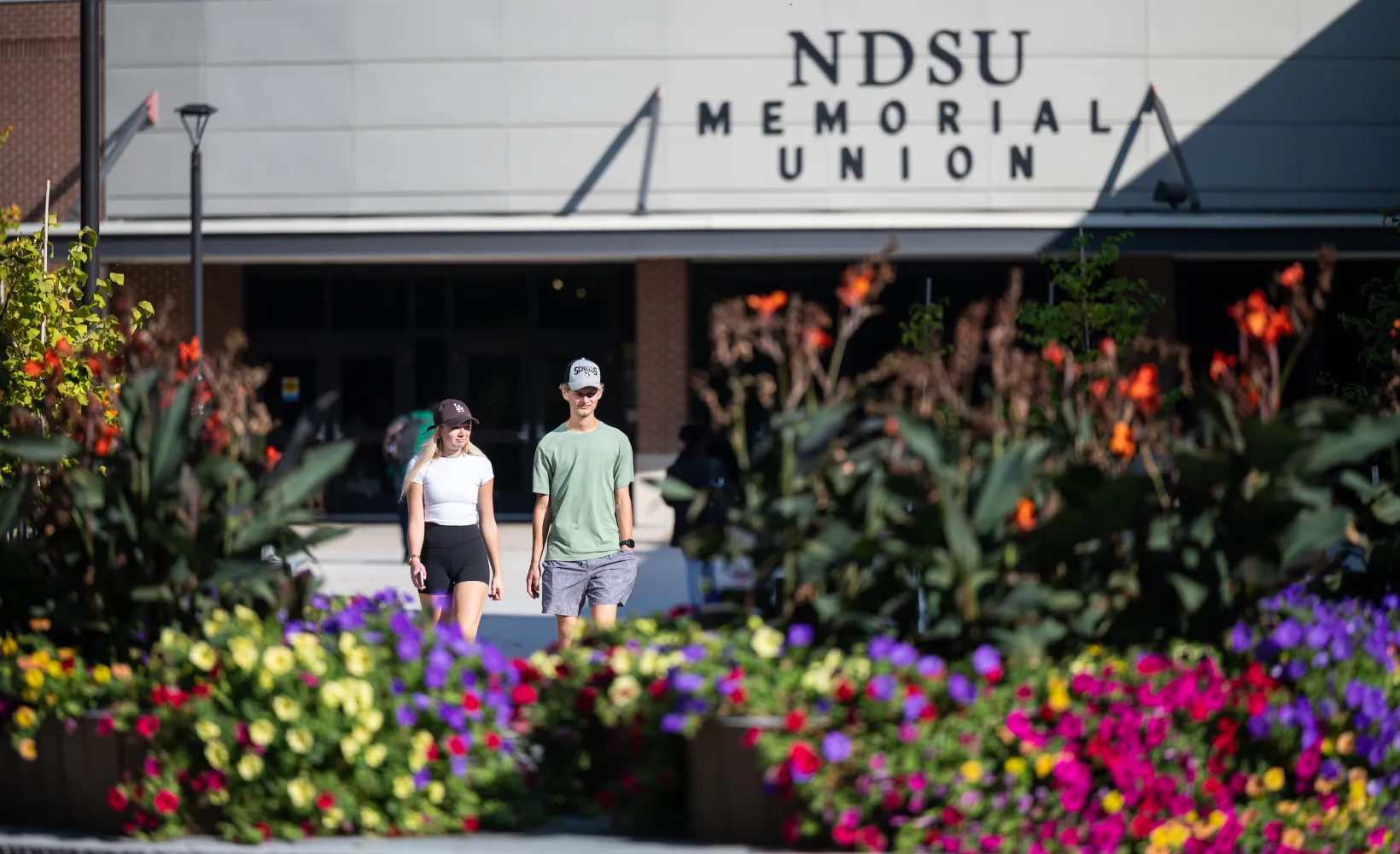 Students walking in front of the NDSU Memorial Union during the spring. 