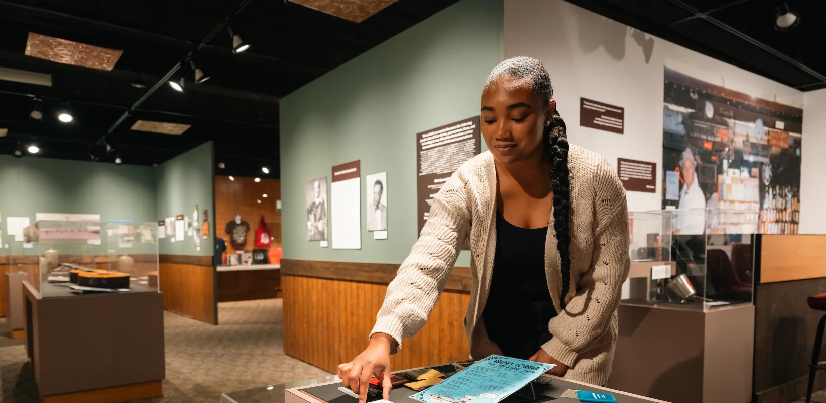 student positioning artifacts for an exhibit in a museum