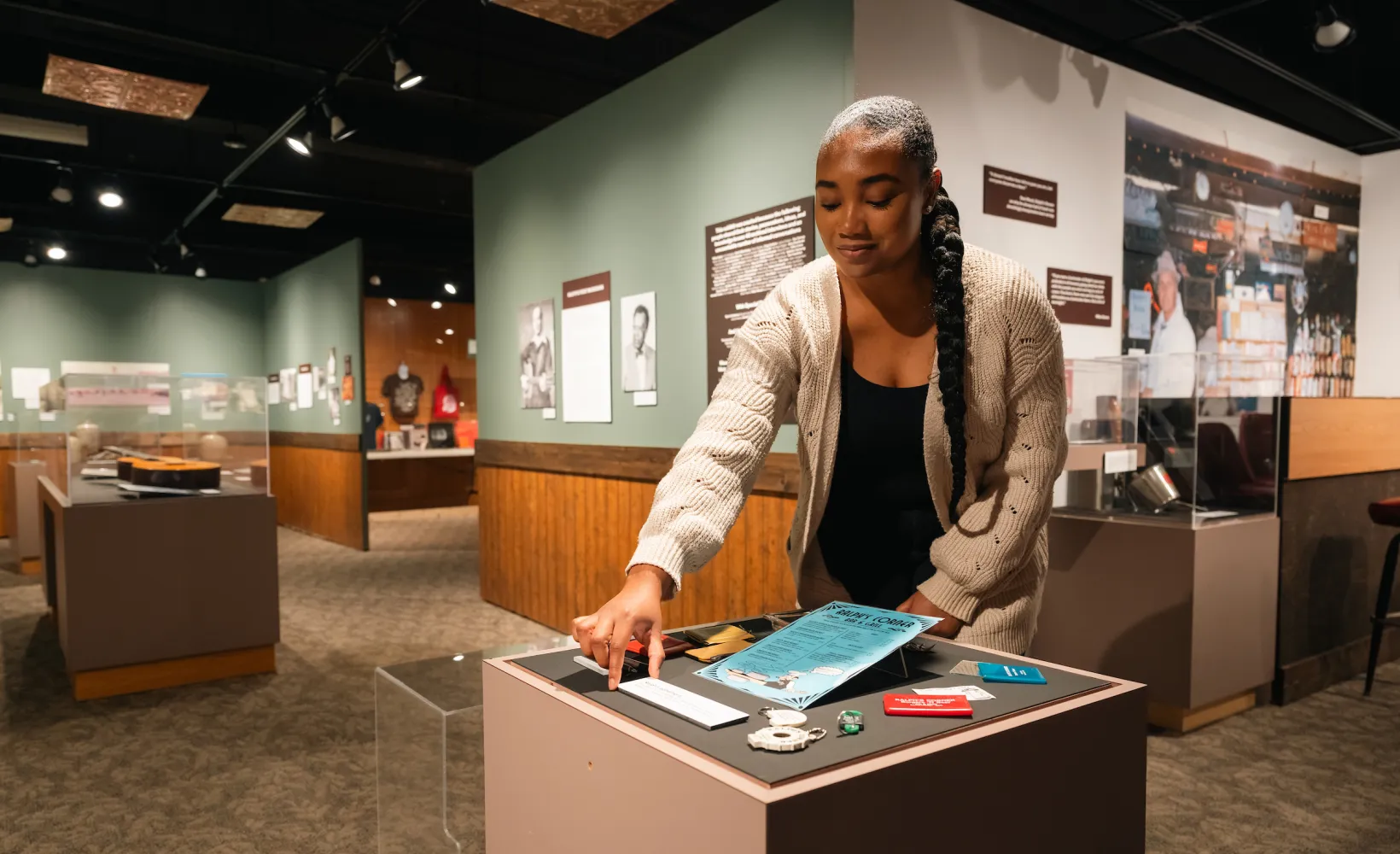 student positioning artifacts for an exhibit in a museum