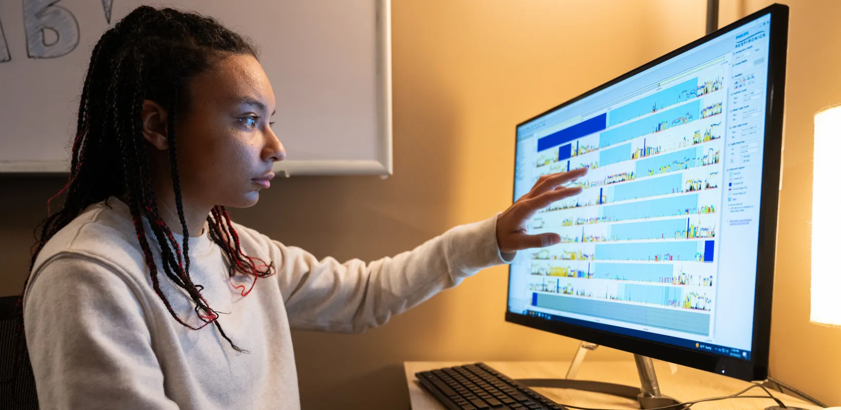 student lookin at charts on a monitor