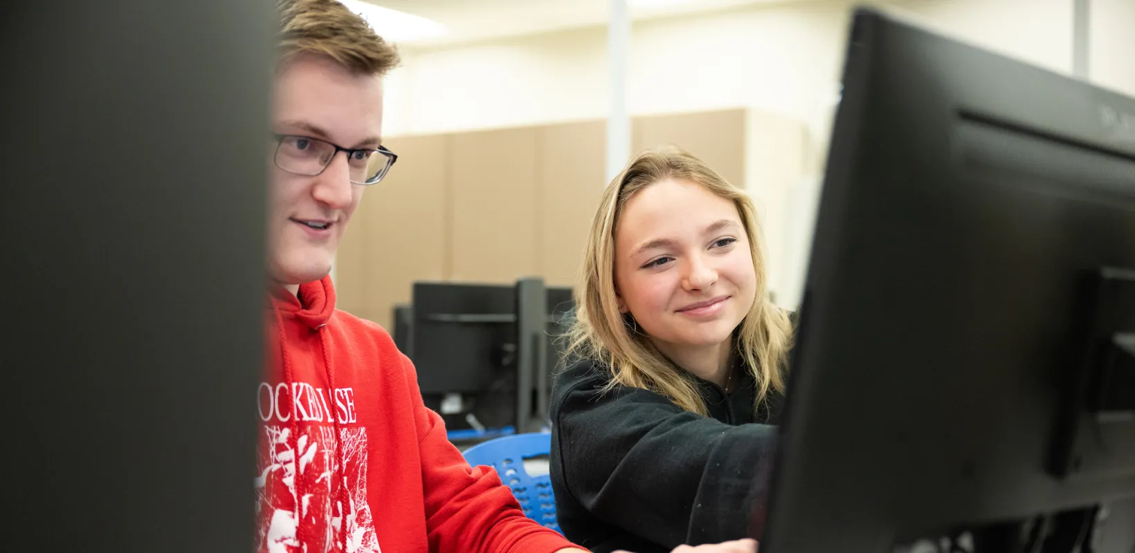 students working on a program in a computer lab