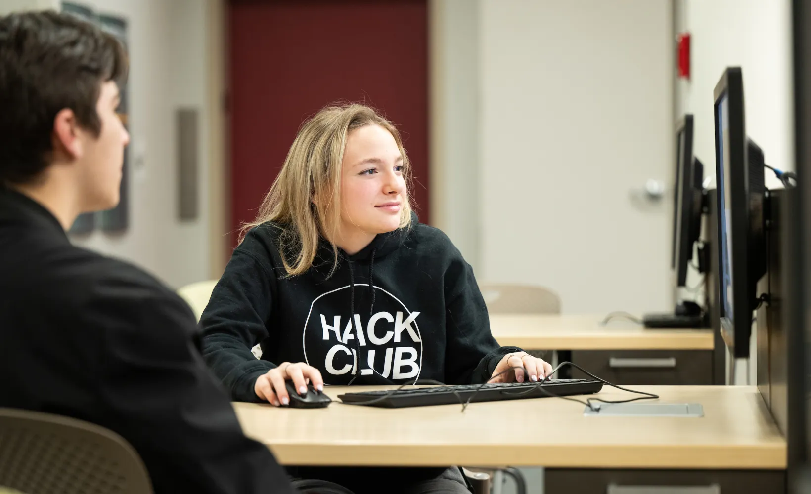 Cybersecurity students working on a project in a computer lab