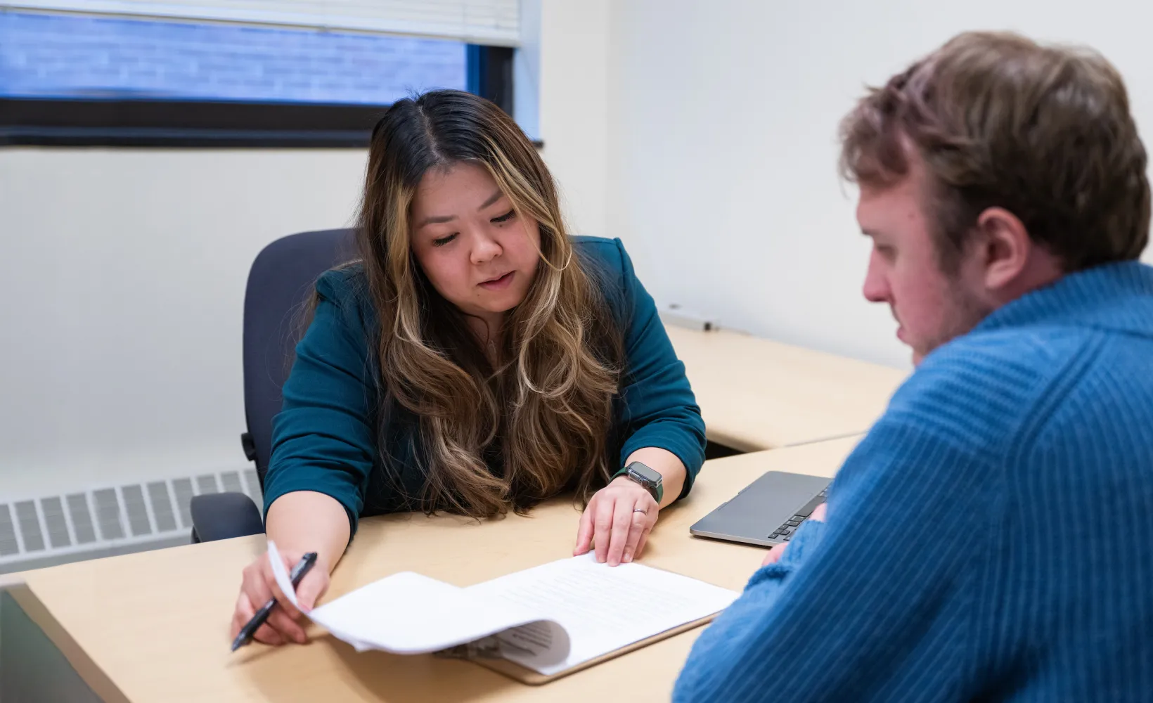 professor meeting with a student to discuss an assignment 
