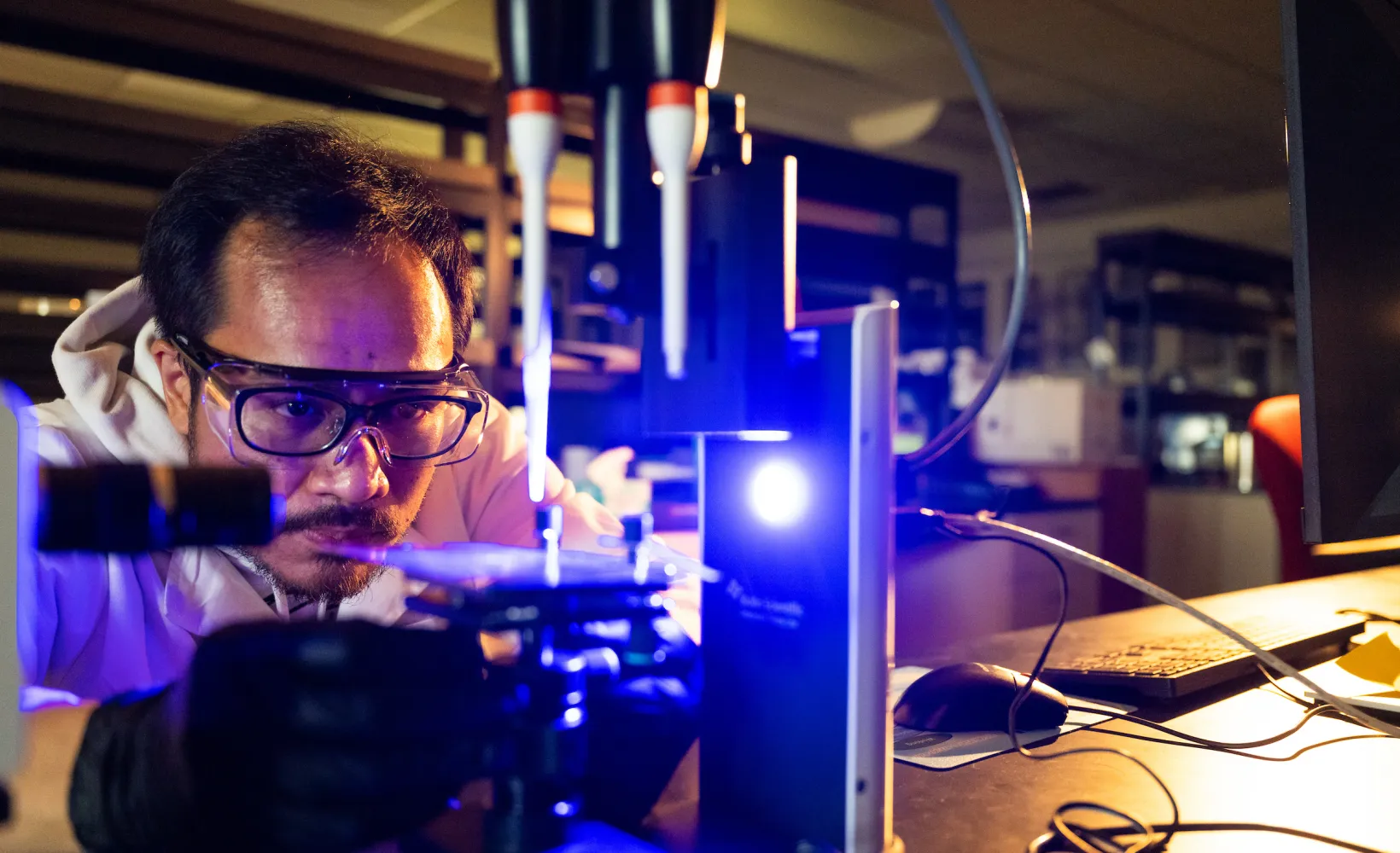 researcher using lab equipment in Coatings & Polymers