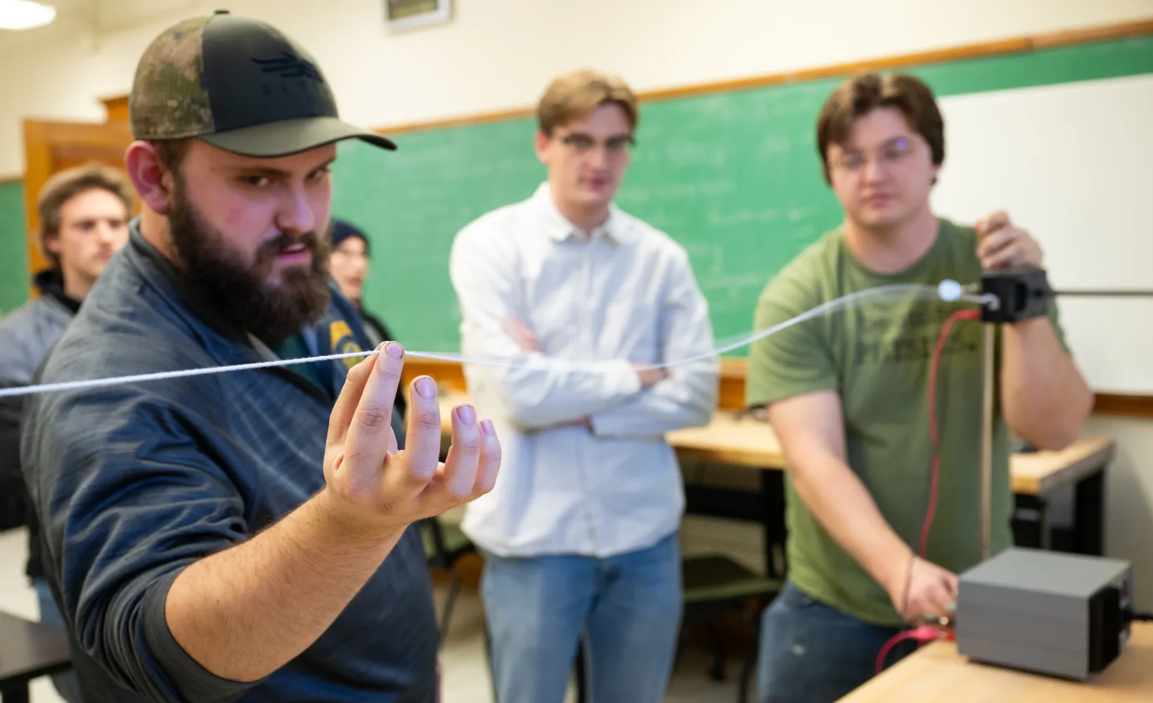 students performing a physics experiment in a classroom
