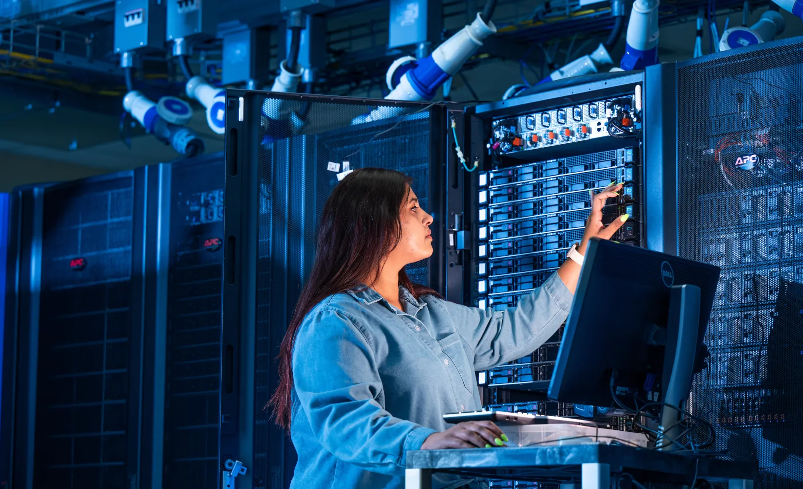 student working on a server in a network room