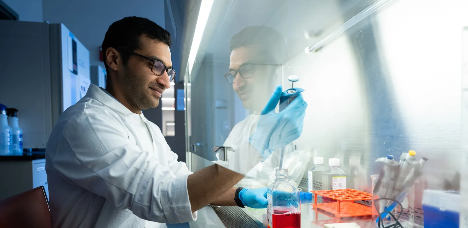 student working with a sample in a lab