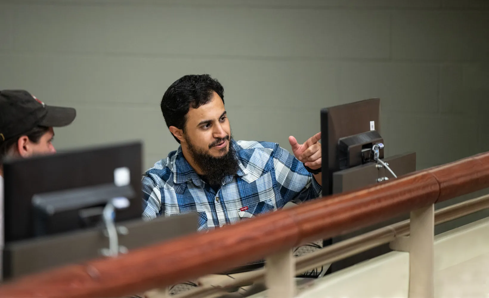 graduate students discussing a project in a computer lab