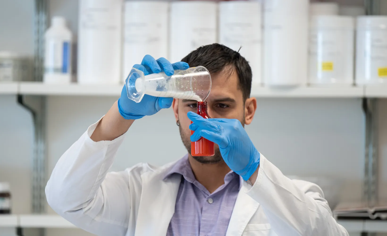 student measuring a substance in a beaker