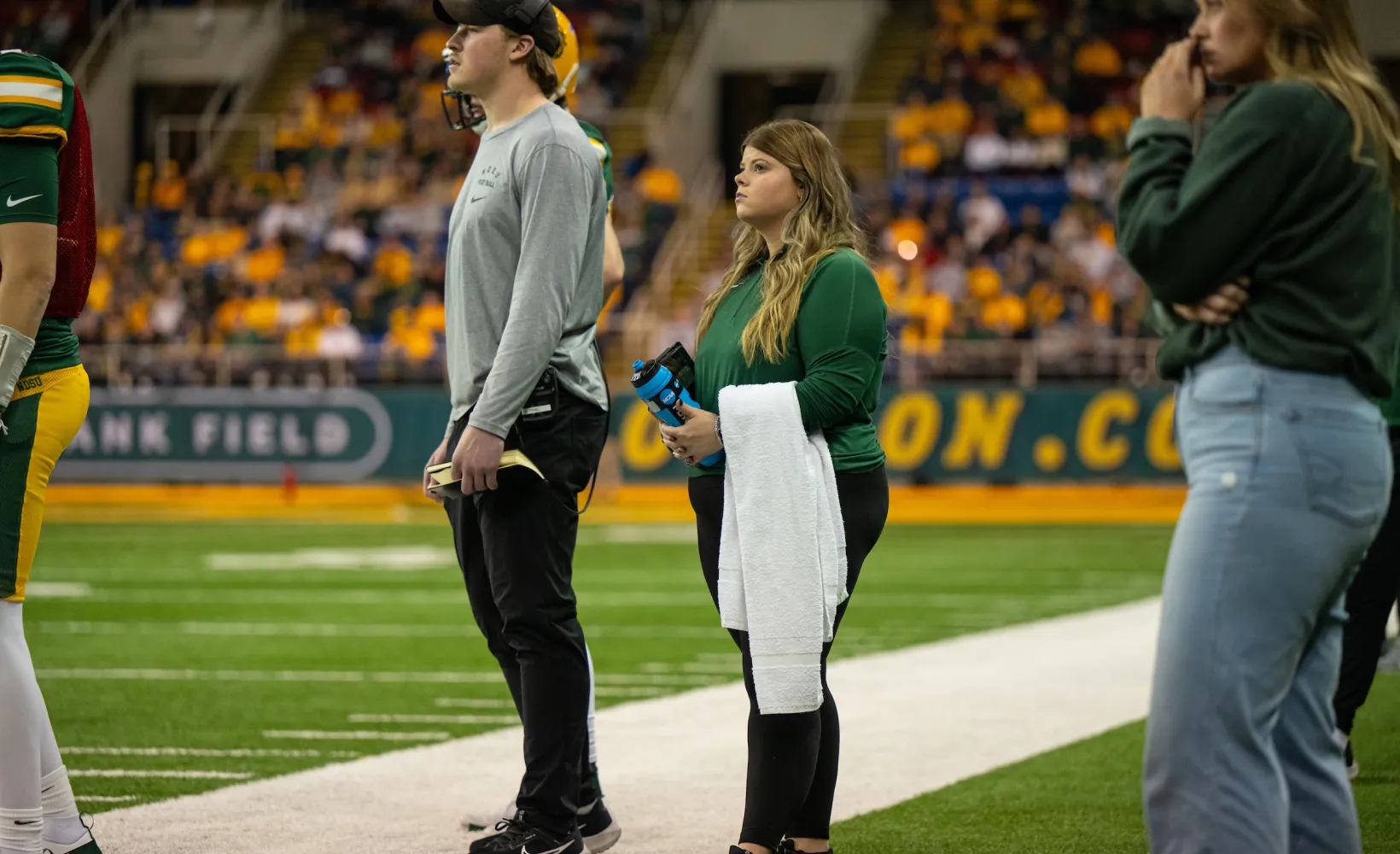 Sport Management students getting hands-on experience on the sideline of a football game