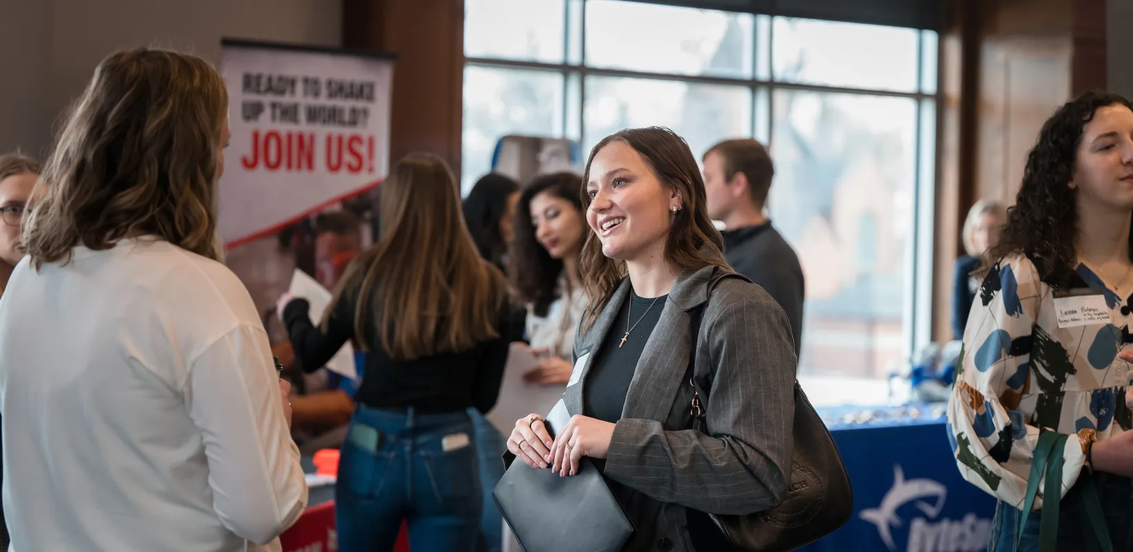 women talking at an expo