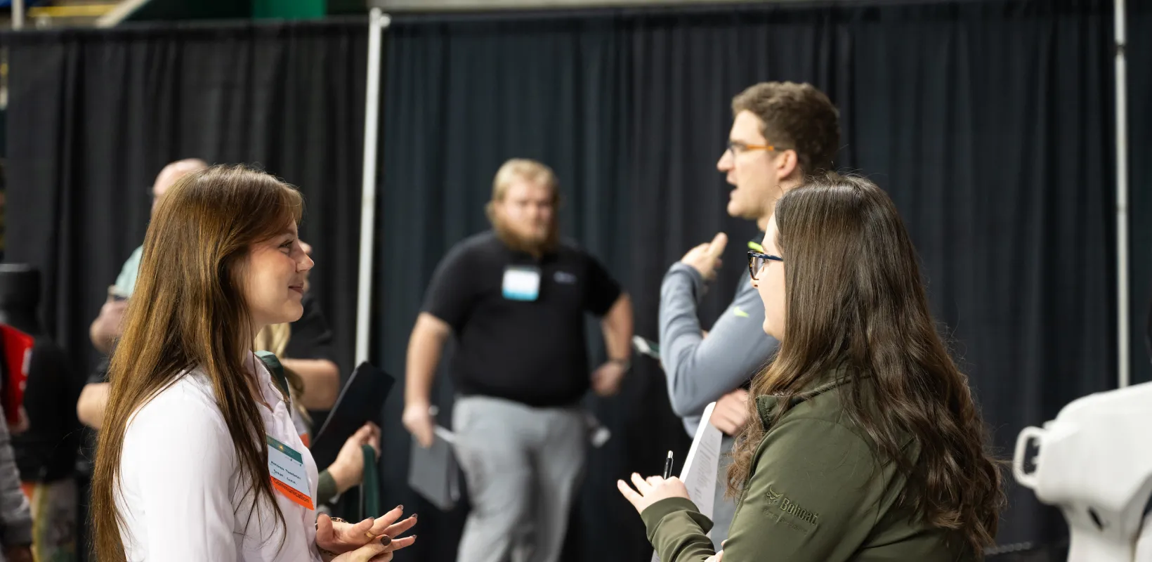 student speaking to an employer at a career fair
