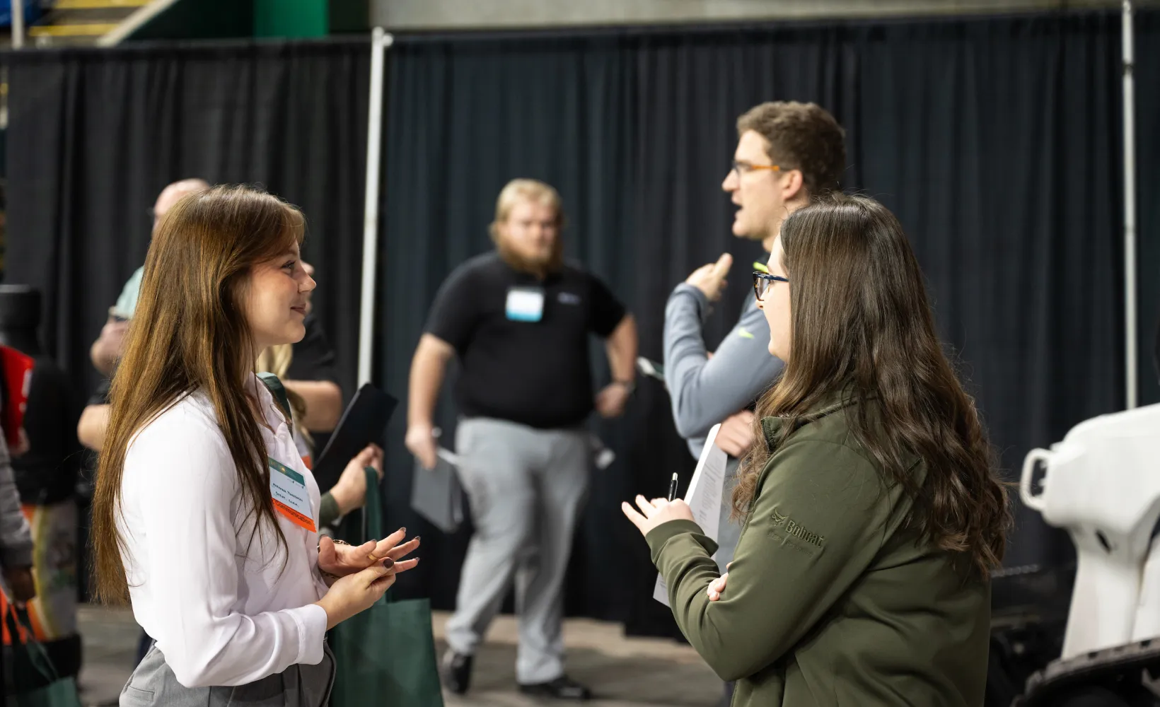 student speaking to an employer at a career fair