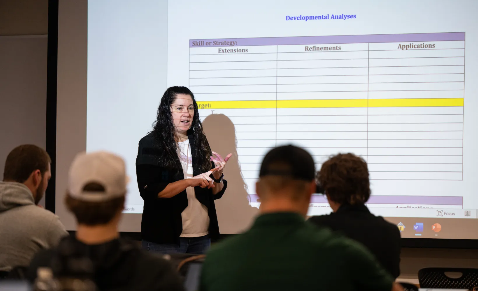 professor presenting a lecture to students in a classroom