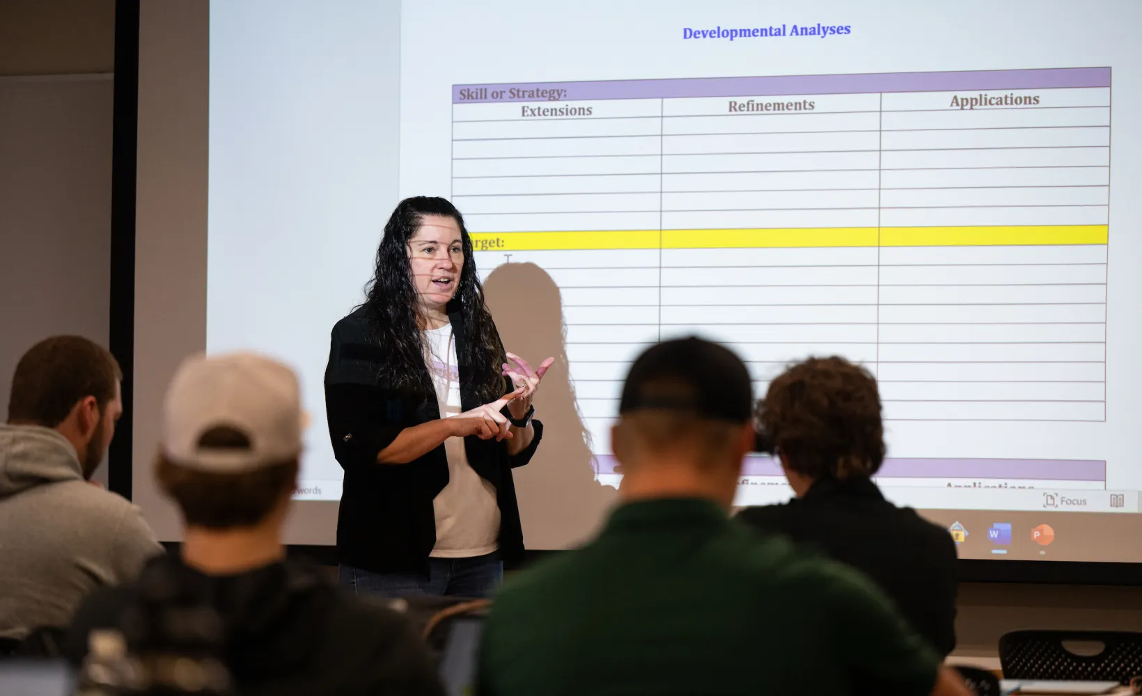 professor presenting a lecture to students in a classroom