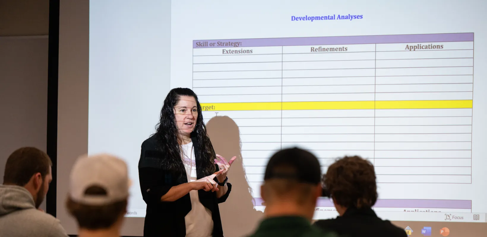 professor presenting a lecture to students in a classroom