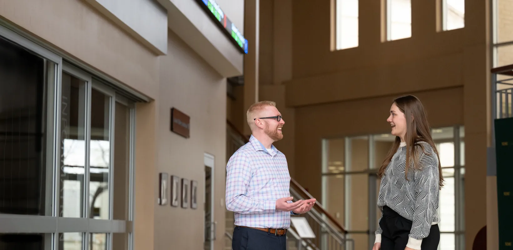two people talking in the lobby of a building