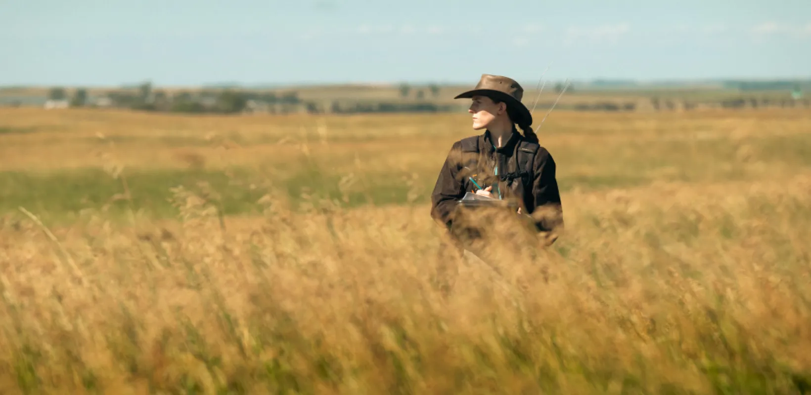 Graduate student in field doing research