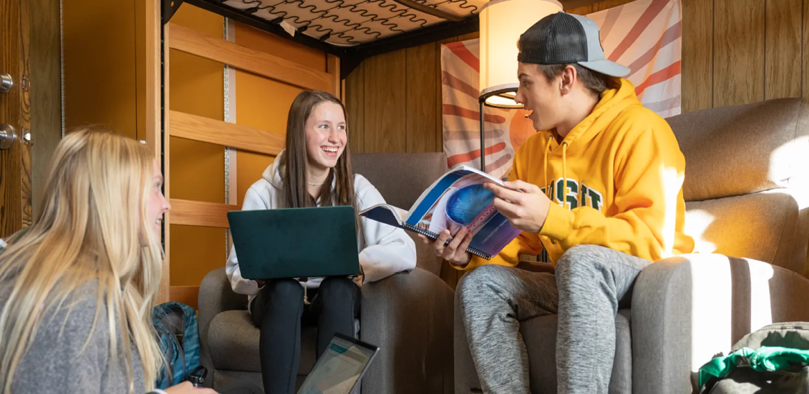 Three students studying in their residence hall room