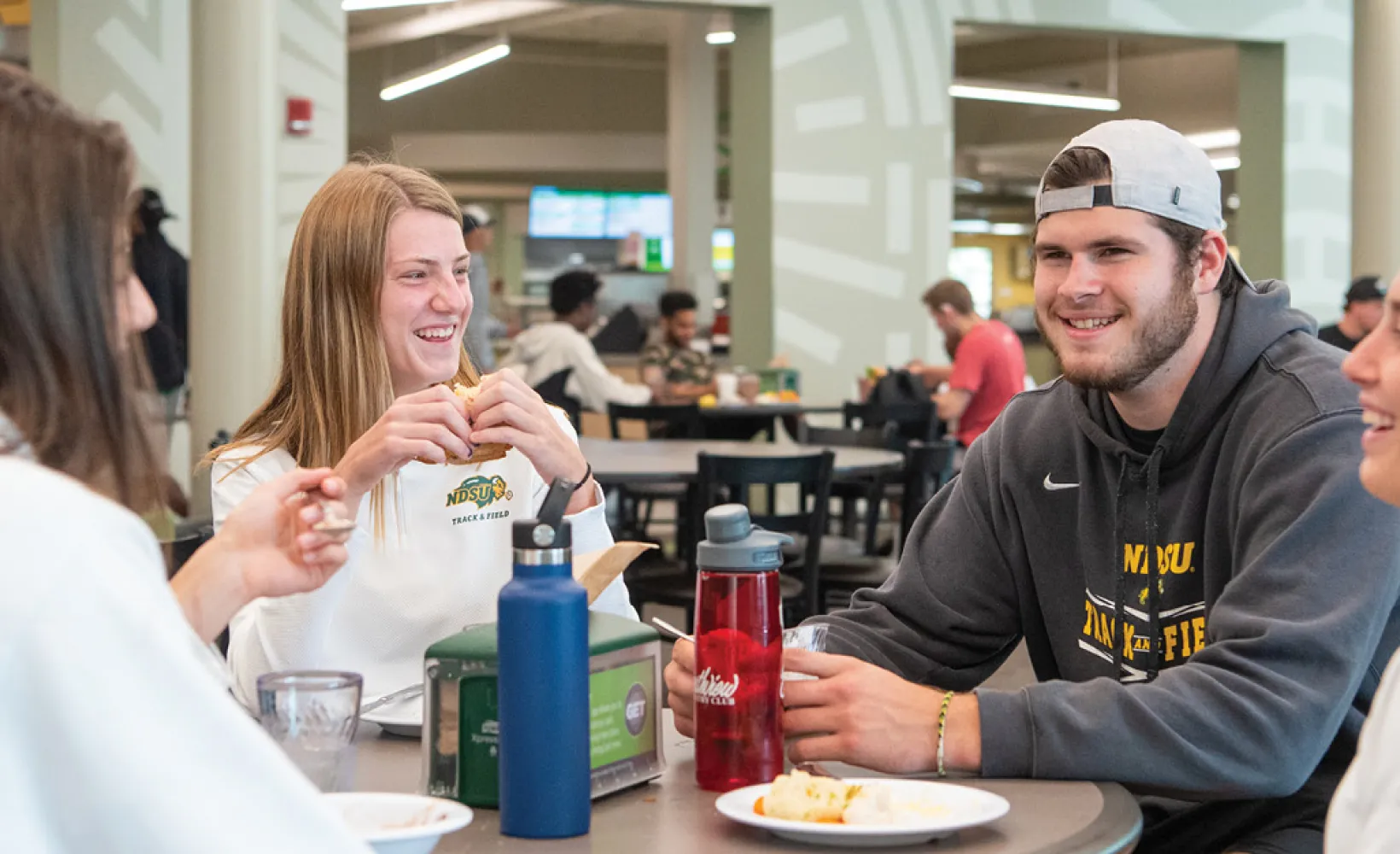Students eating at a table and laughing at the WDC