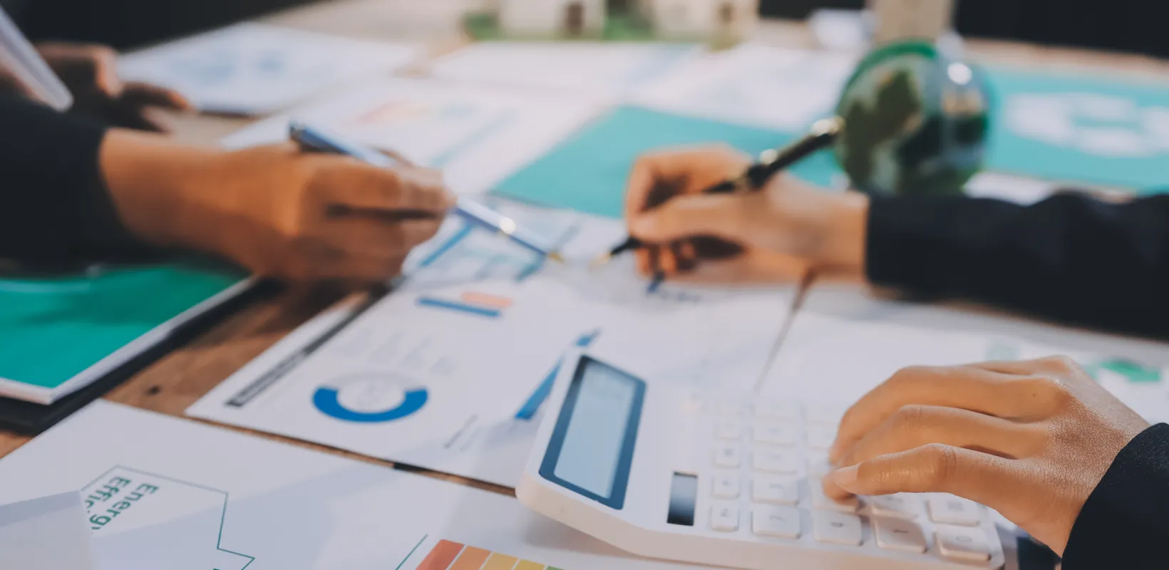 two students evaluating real estate charts and graphs