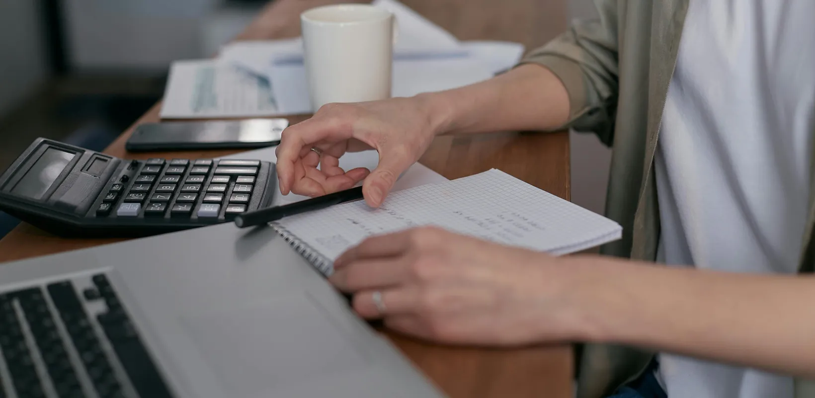 student reading notes in a coffee shop