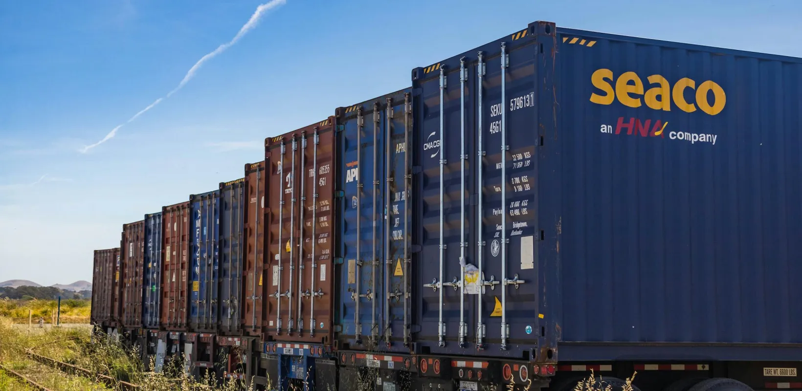 shipping containers sitting in a field