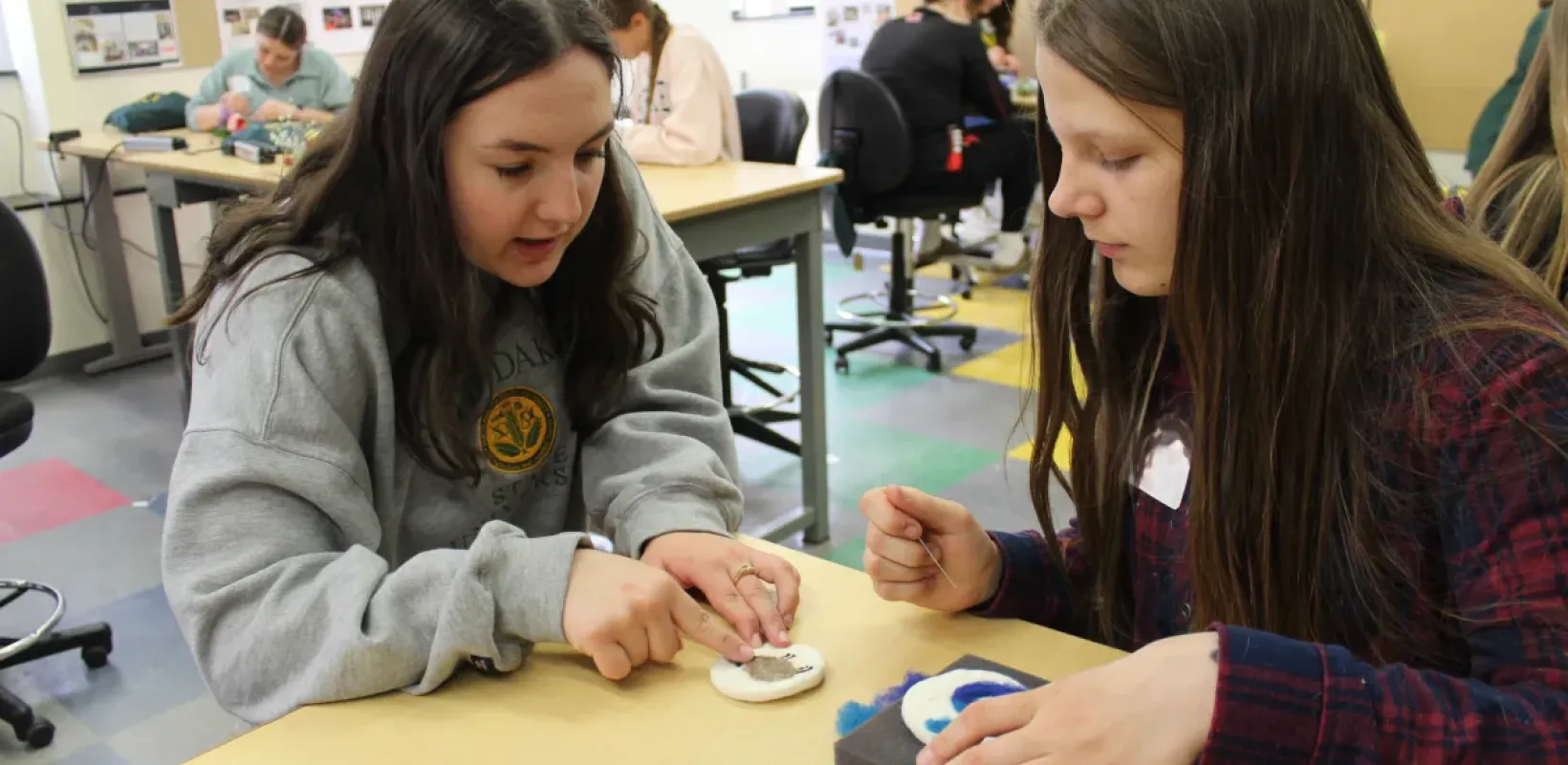 teacher teaching student in classroom
