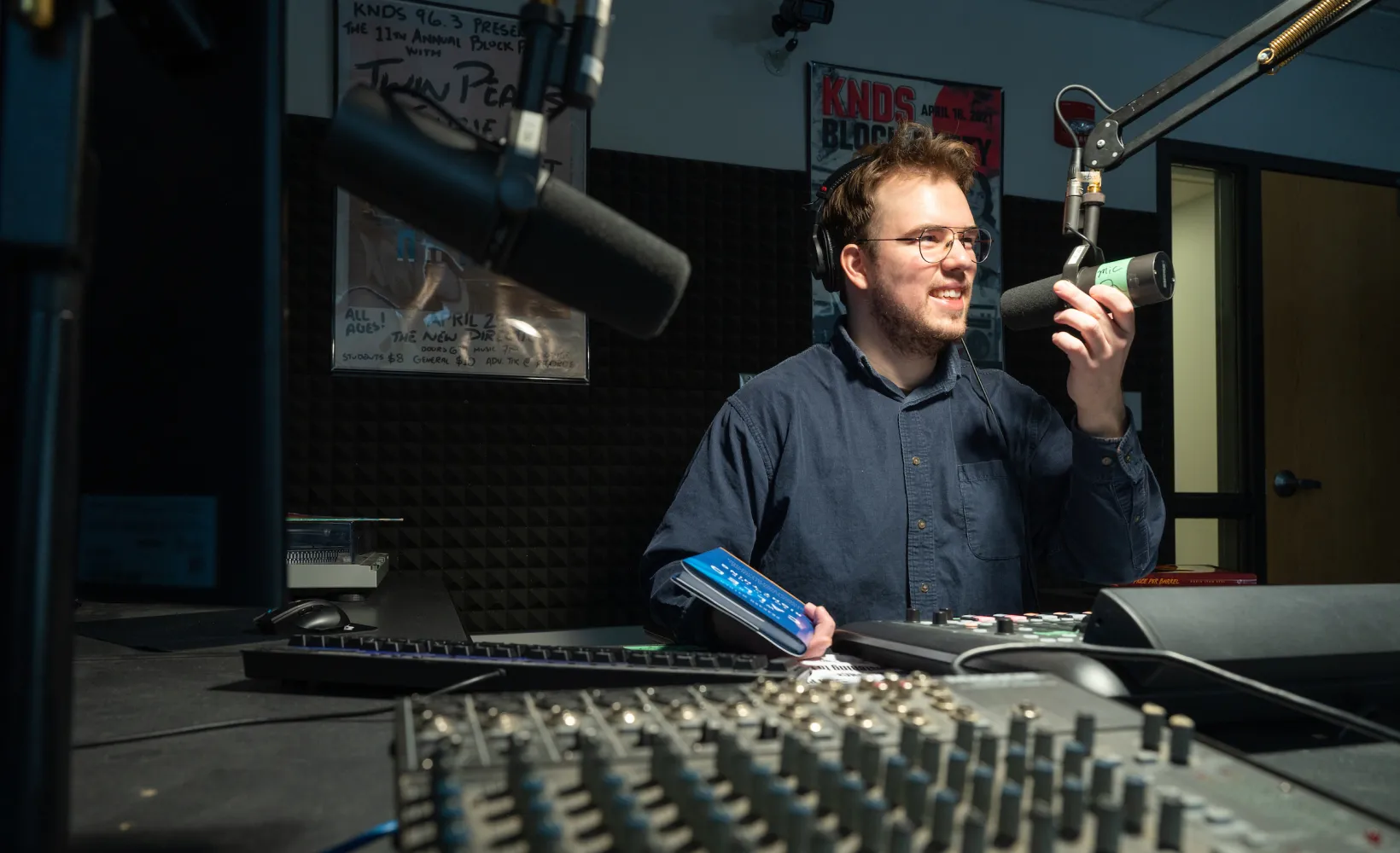 student running a podcast and working in the sound studio