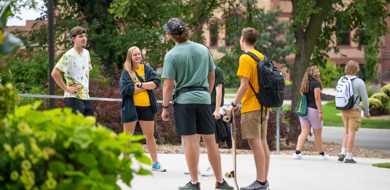 Students standing outside on the NDSU campus tlaking and hanging out
