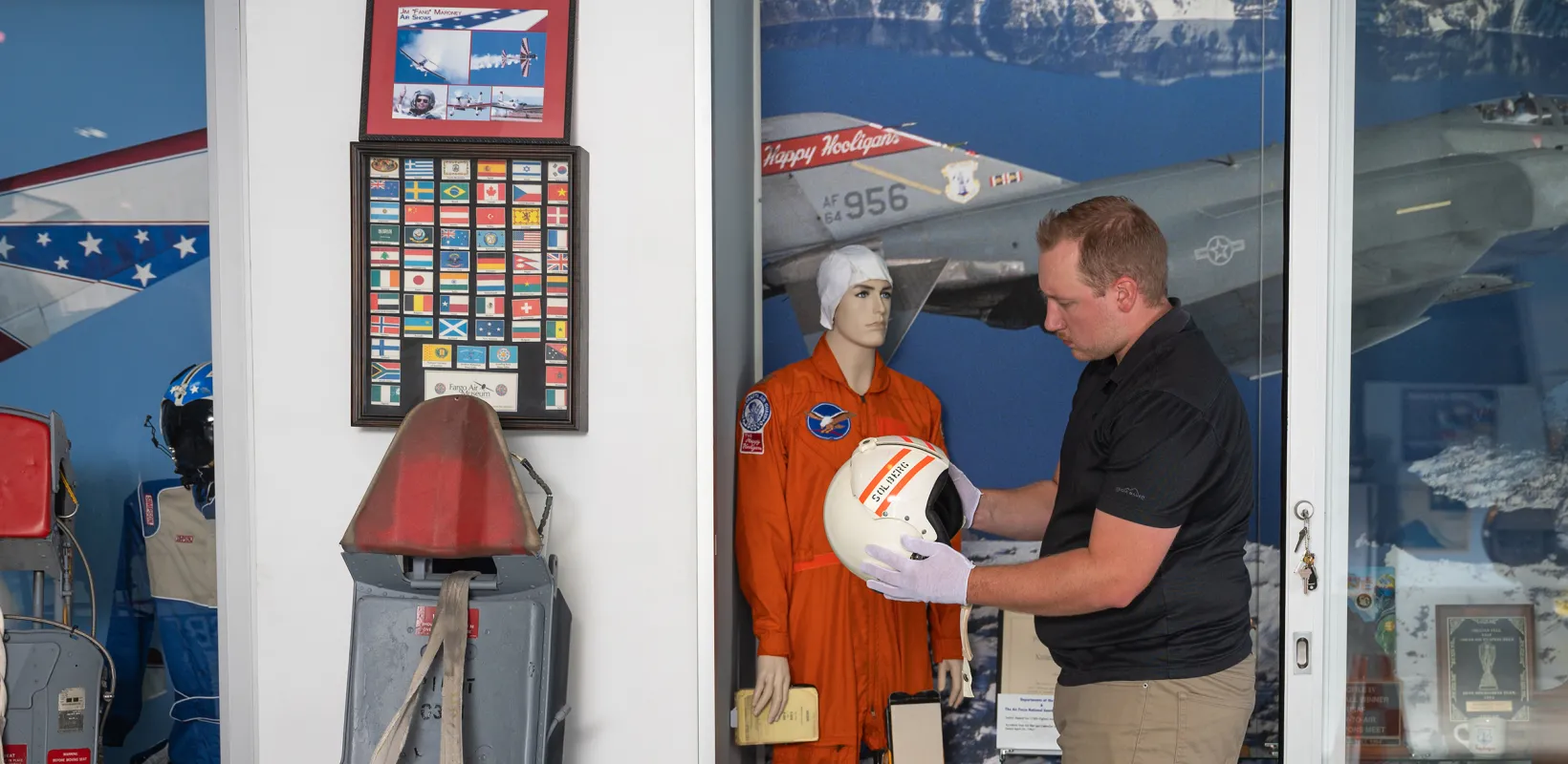 student working at Fargo Air Museum with historical memorabilia