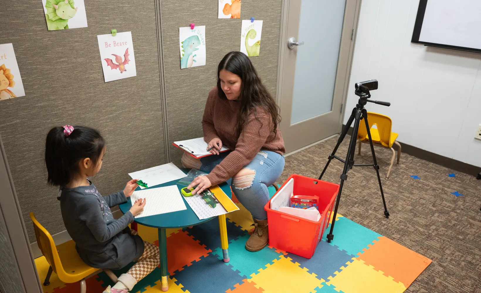 student working with young child in a human development and family science research lab