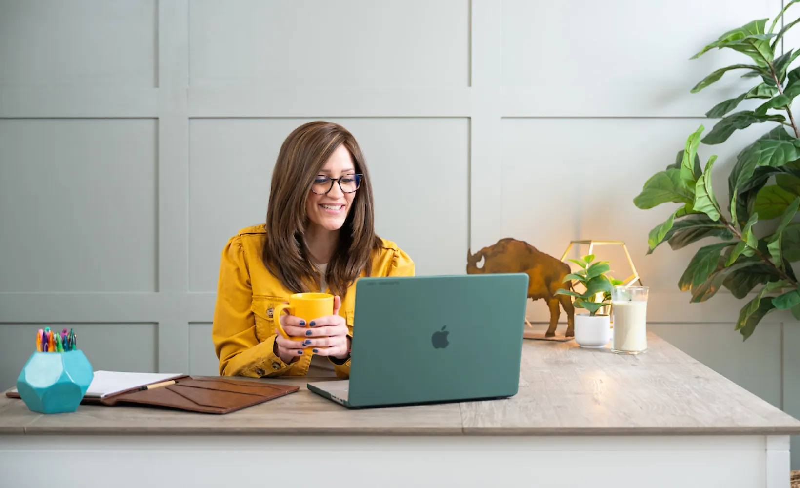 graduate student working on laptop in home office