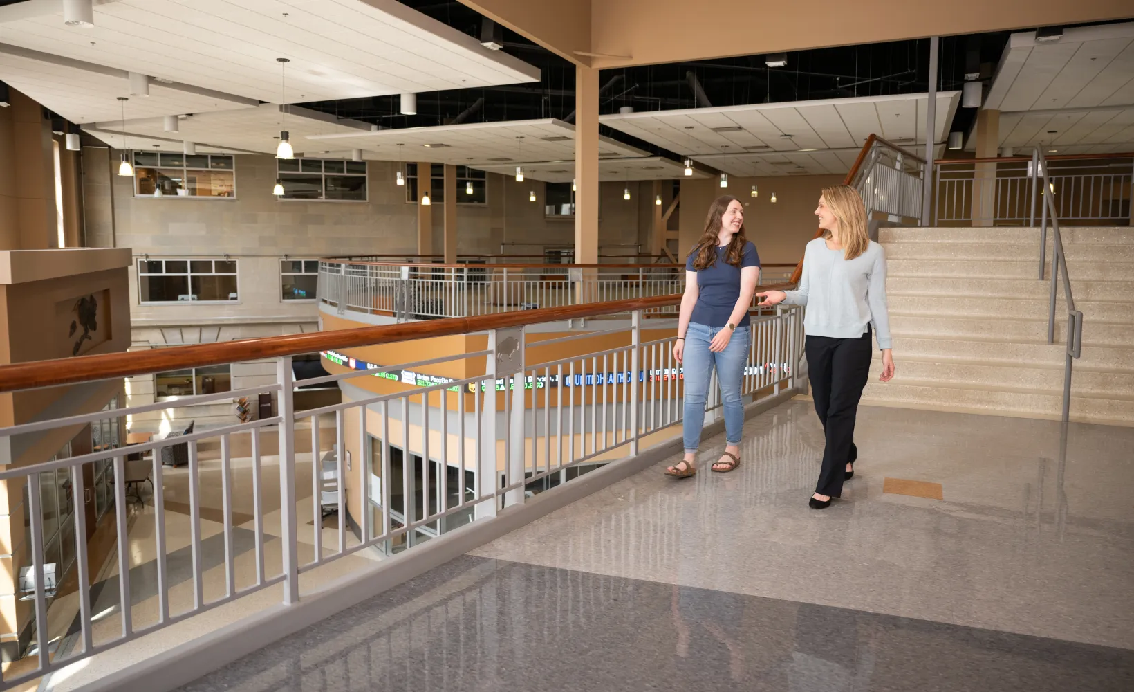 Advisor walking in hallway with student in Barry Hall.