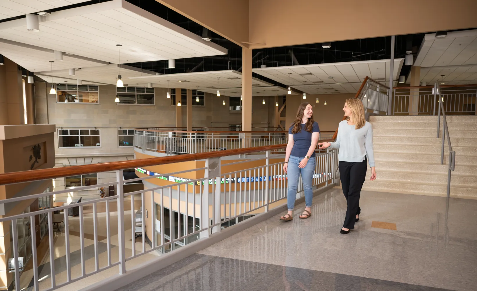 Advisor walking in hallway with student in Barry Hall.