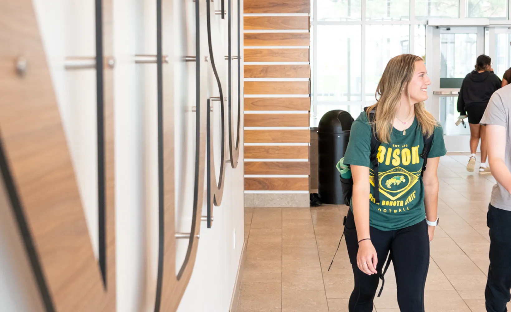 three students walking out of Cater Hall