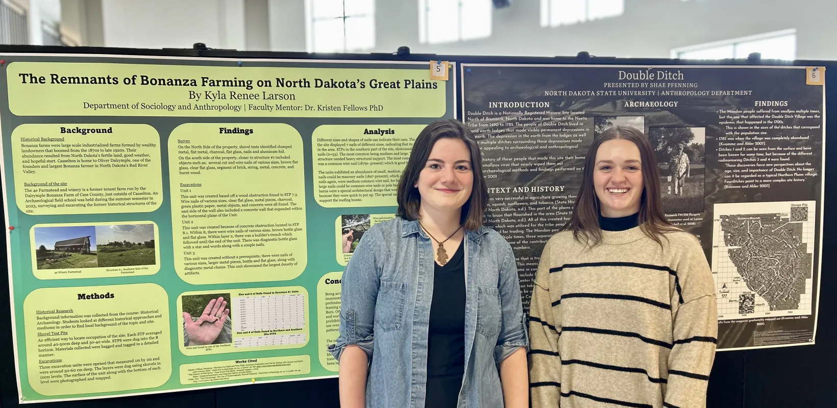 Two students standing in front of a research poster.