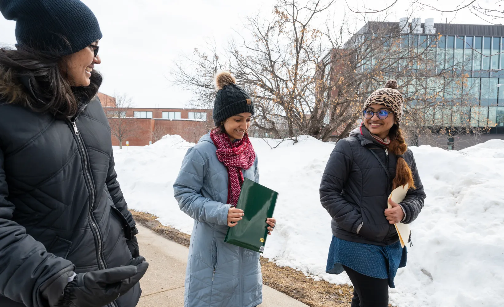 3 international students walking side by side in the snow
