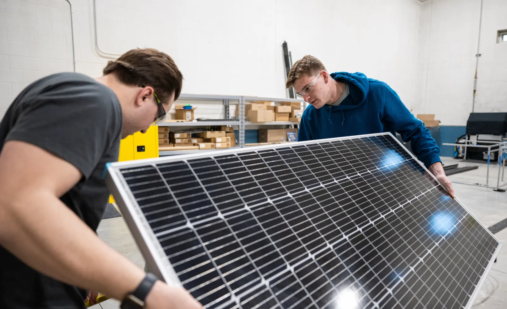 Engineering students working with a solar panel