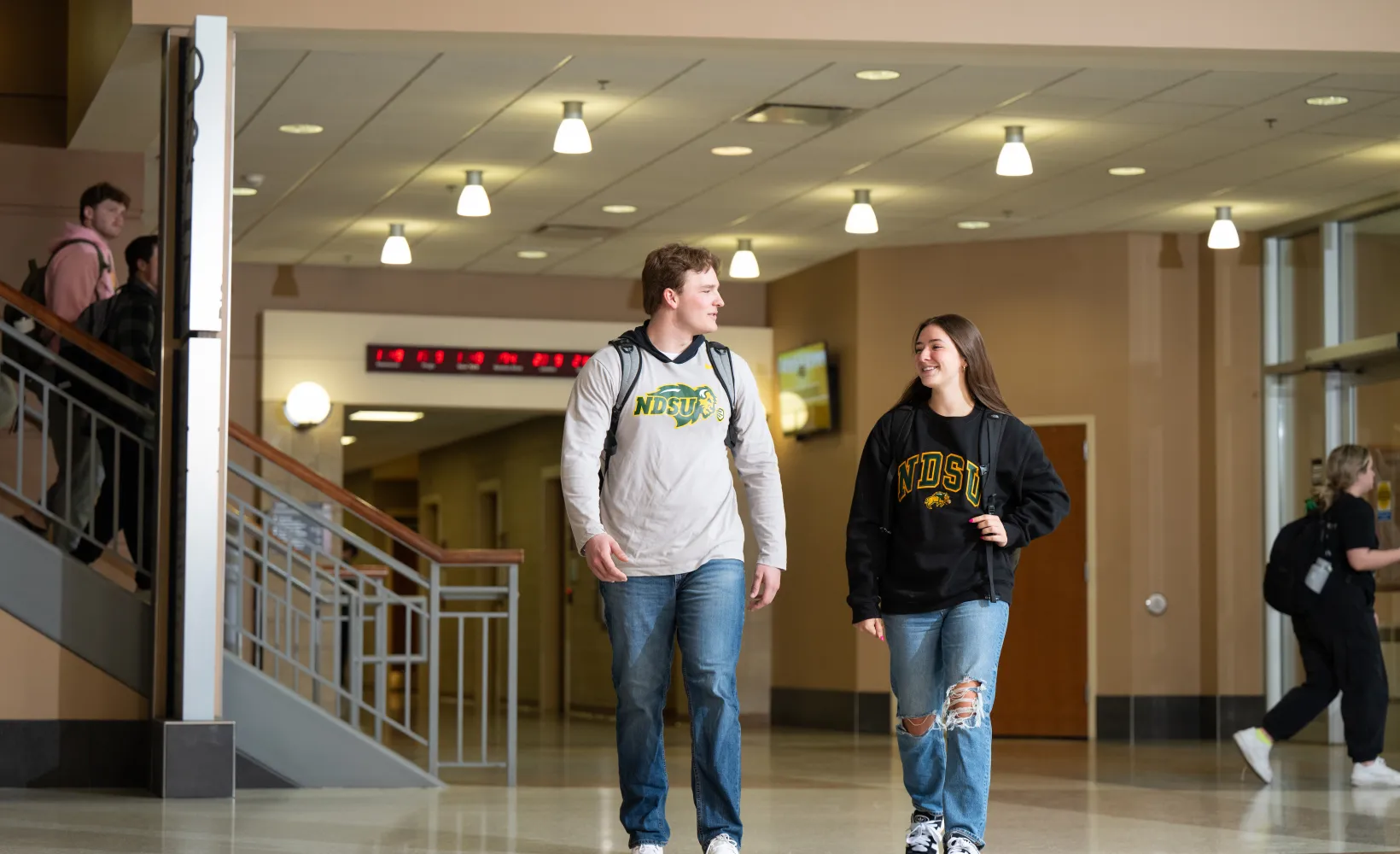 Two students walking in Barry Hall.