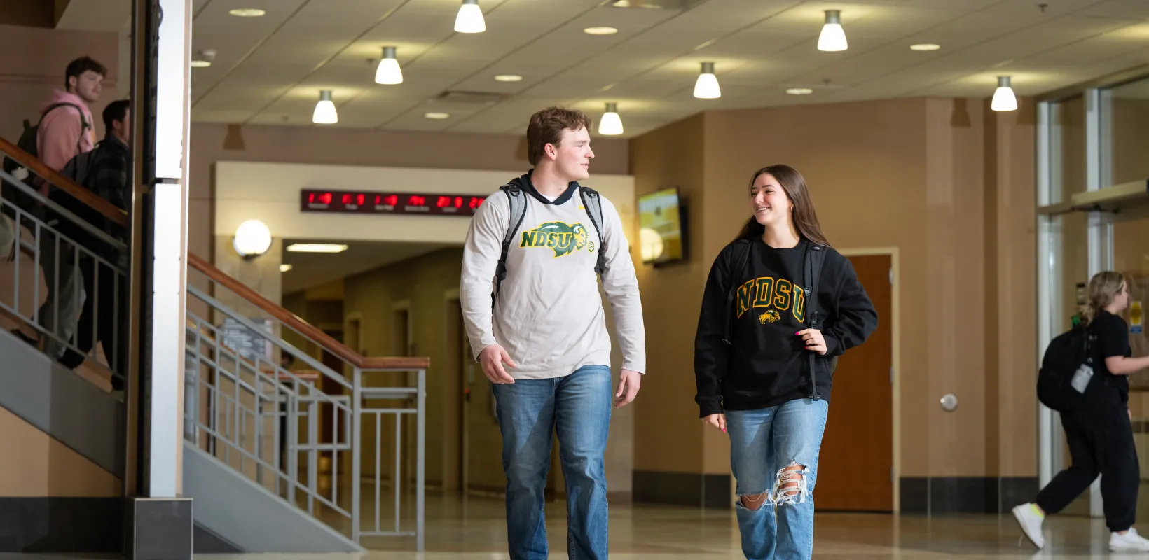 Two students walking in Barry Hall.